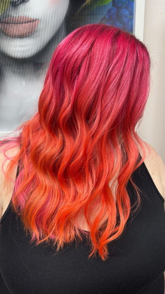 vibrant pink to orange sunset hair melt with soft waves by Jennifer Bass Billman Oklahoma City