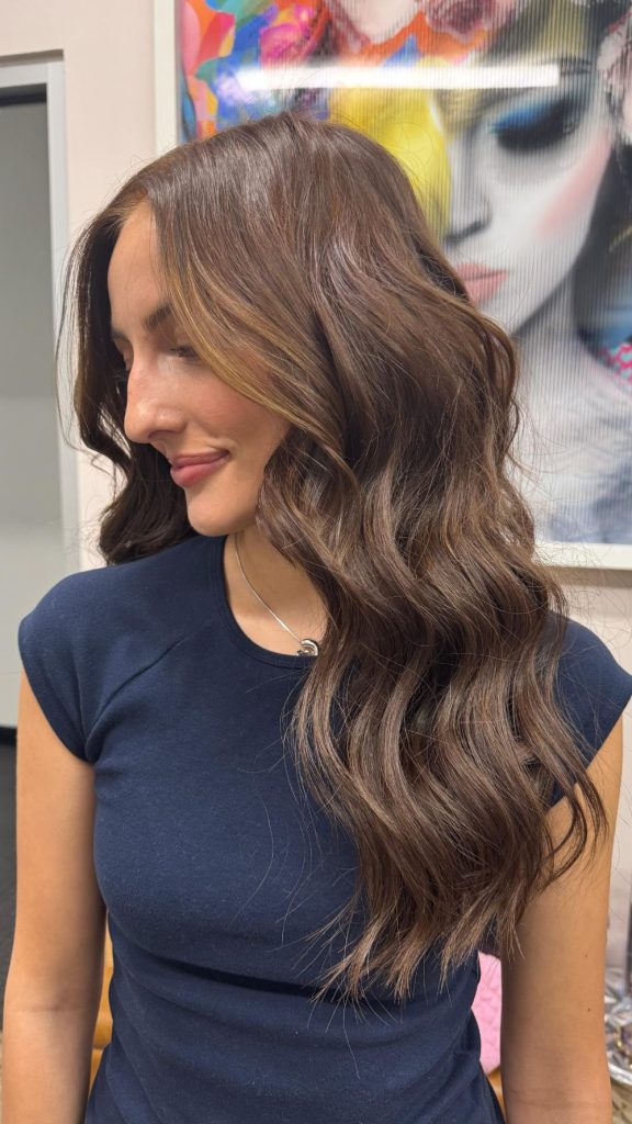 Soft brunette waves created with Natural Beaded Row hair extensions and blended face-framing highlights